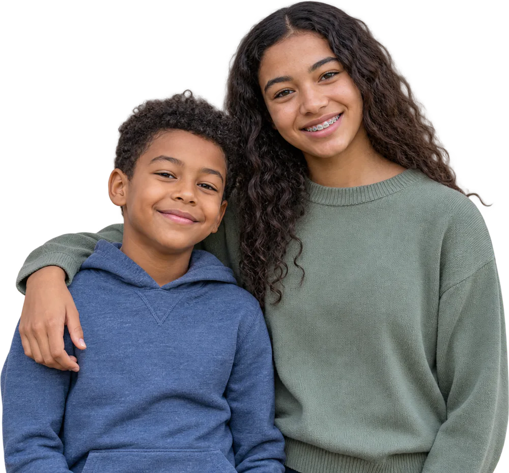 A smiling child beside a teenager wearing braces